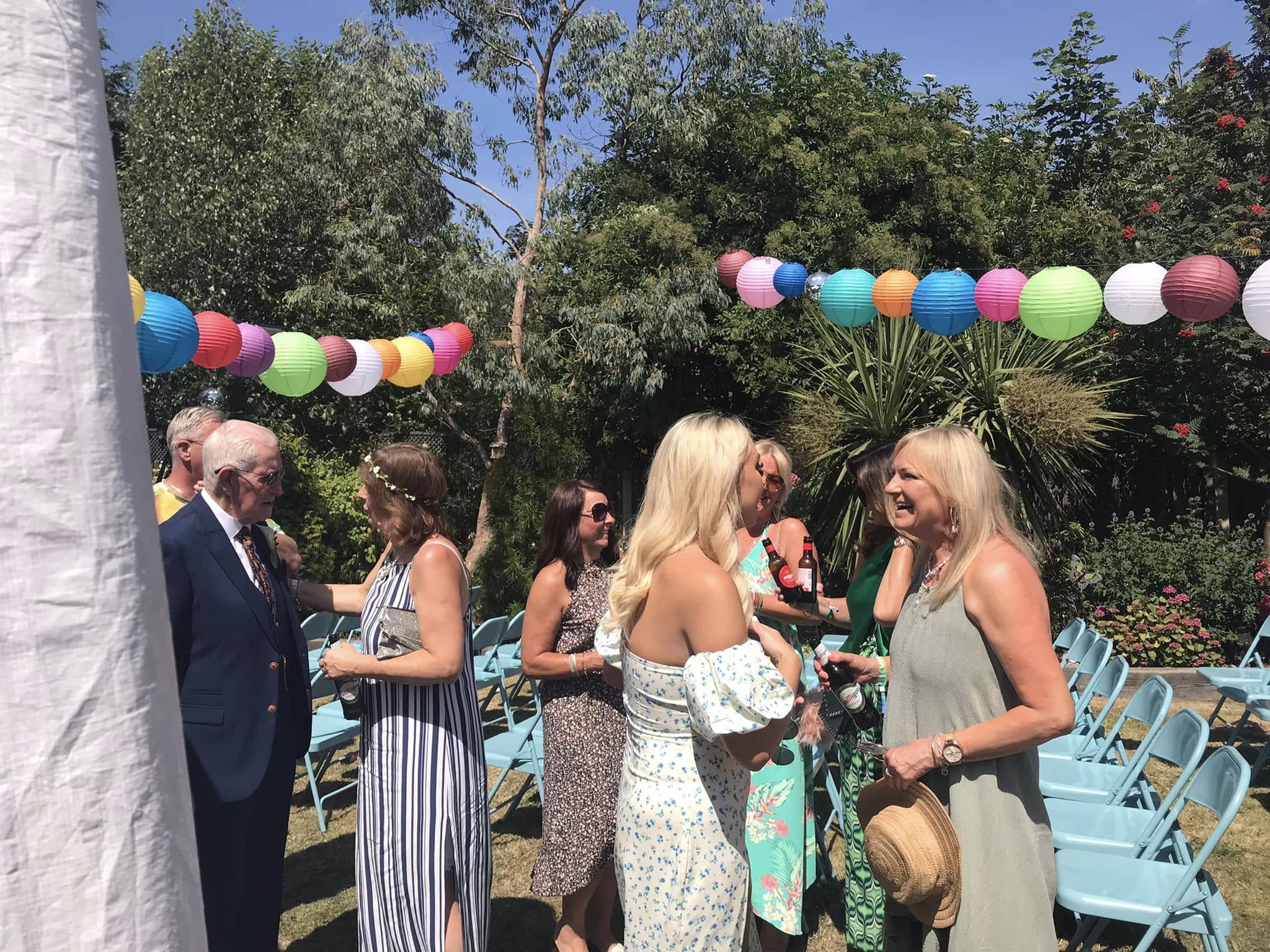 Wedding guests enjoying a colourful outdoor celebration